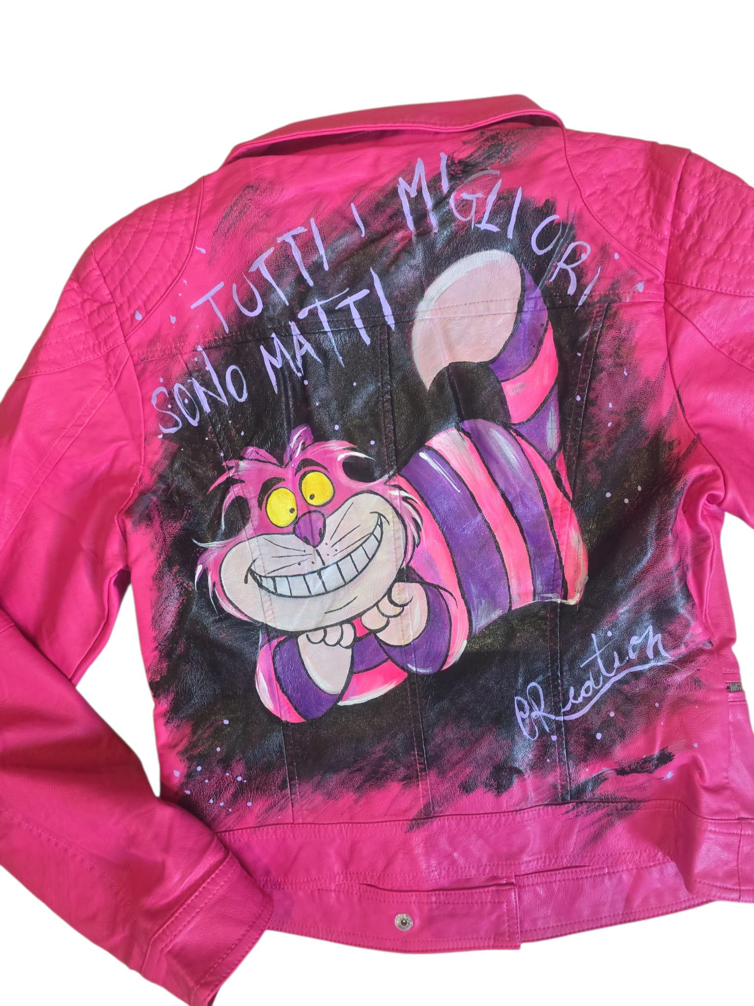 *🎨 Giacca in pelle dipinta a mano con soggetto principale ispirato al famoso Stregatto e la frase: *"Tutti i migliori sono matti"* 🐱✨ Un capo unico, originale e realizzato artigianalmente per chi ama distinguersi! 🧵 *Personalizzabile*: puoi richiedere variazioni del personaggio, della frase o anche del tipo di tessuto (ad esempio ecopelle, jeans o altro materiale a scelta). 