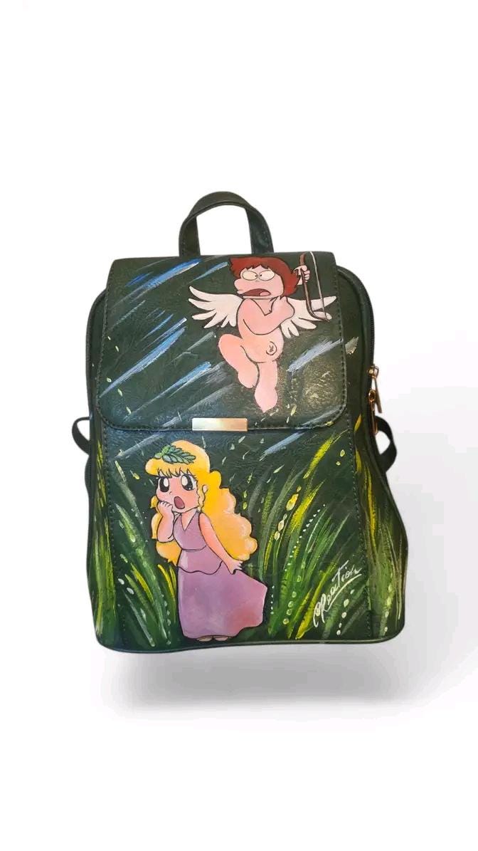 Borsa dipinta a mano – Personaggio Pollon | Cartone vintage anni ‘80 | Personalizzabile | Idea regalo originale 🎨 *Borsa artigianale dipinta a mano* con il soggetto iconico di *Pollon*, la simpatica dea pasticciona che ha fatto sognare intere generazioni! Un omaggio divertente e nostalgico agli amanti dei *cartoni vintage anni ‘80*.