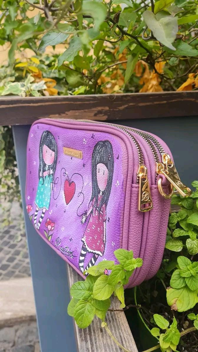 Borsa Dipinta a Mano - Il Filo Rosso che ci Unisce | Simbolo di Connessione e Amicizia ✨ Un accessorio unico, simbolo di legami indissolubili! ✨ Questa borsa speciale è dipinta a mano con colori acrilici resistenti e raffigura due bambine unite da un filo rosso con un cuore al centro, simbolo di connessione, amicizia e amore destinato. Perfetta per chi crede nel legame invisibile che unisce le anime, rendendole inseparabili.