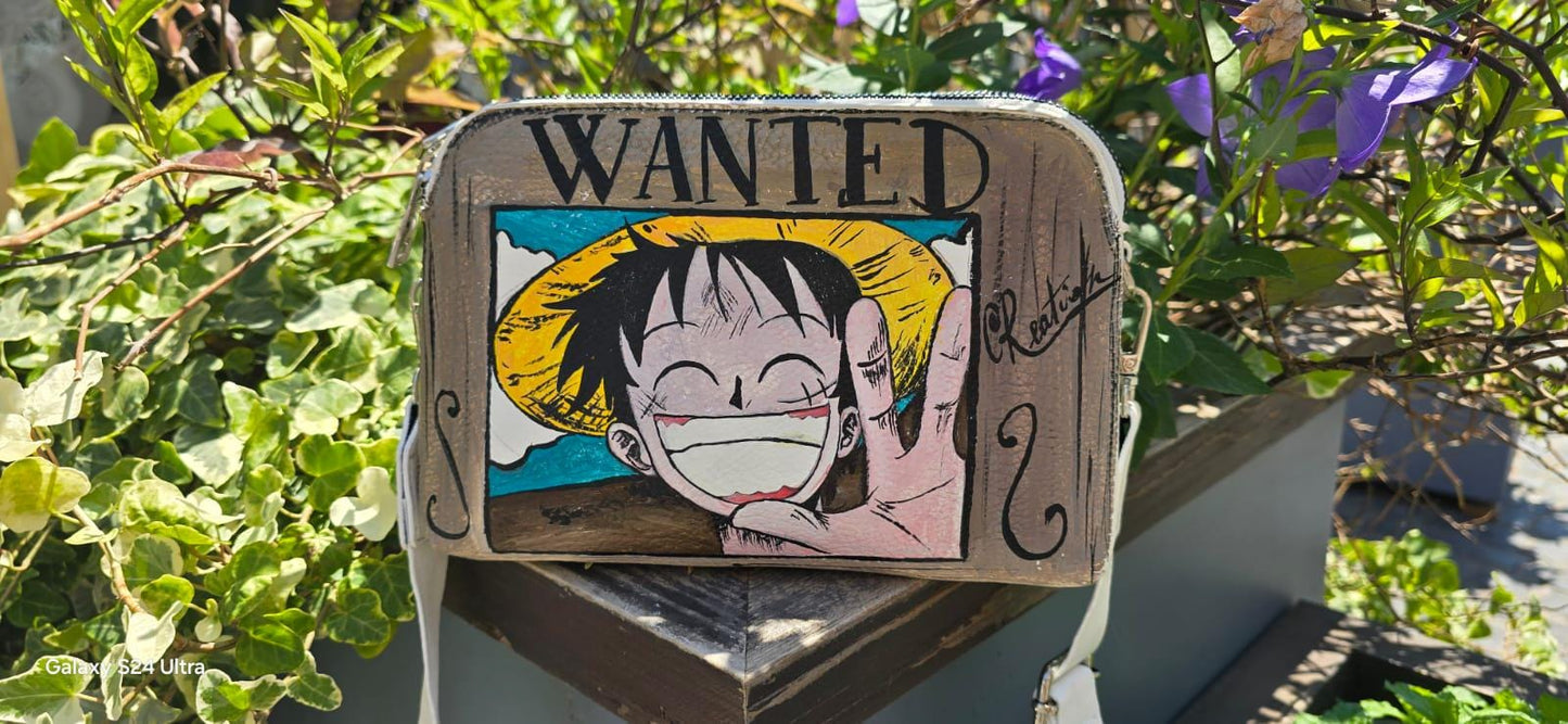 *Borsa Dipinta a Mano – Rubber Cappello di Paglia (One Piece) 🏴☠️🎨* Un accessorio unico per veri fan di One Piece! Questa *borsa in ecopelle dipinta a mano* ha come soggetto principale *Rubber (Luffy)* con il suo iconico *cappello di paglia*, simbolo di libertà e avventura. Realizzata con *colori acrilici professionali*, ogni borsa è un pezzo artigianale unico, perfett