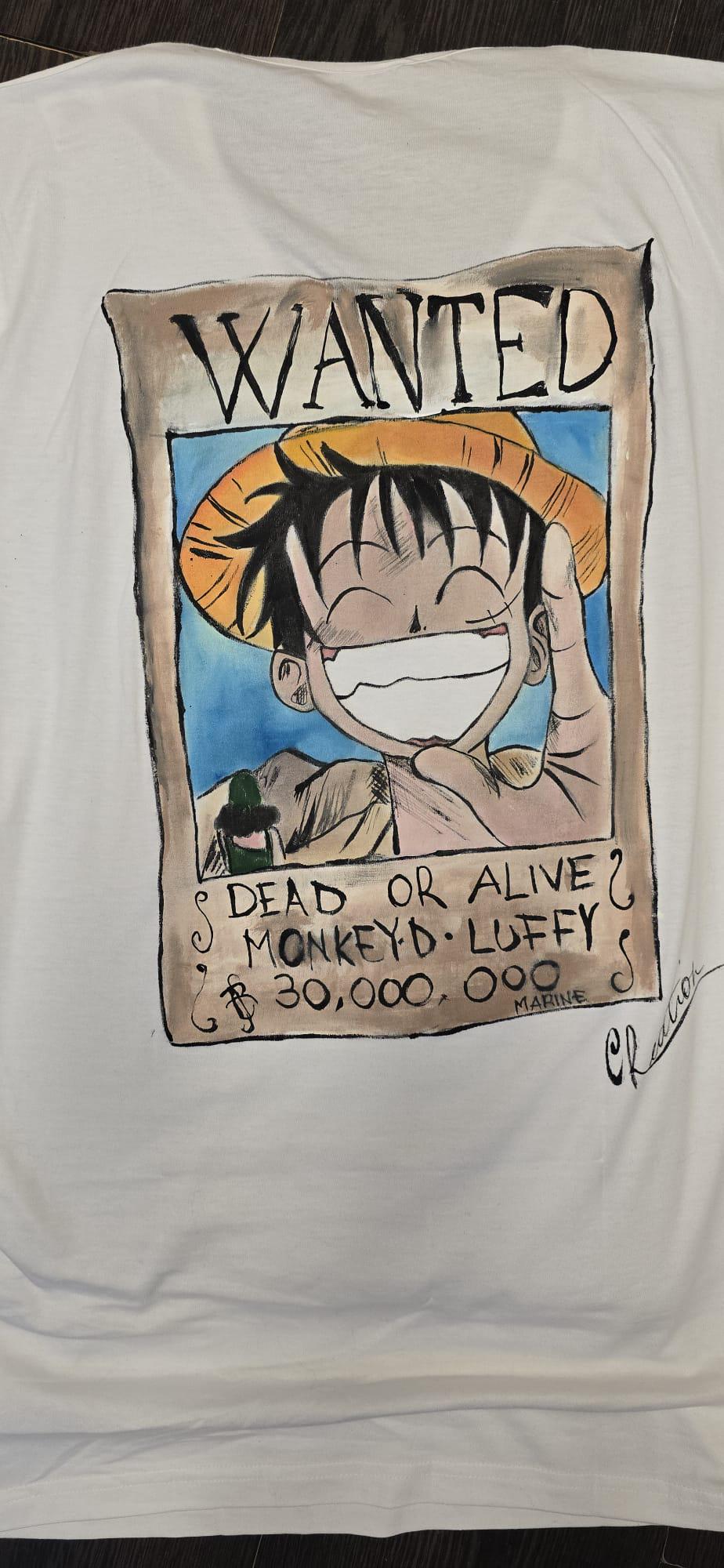 🎨 Descrizione prodotto:  
Maglietta bianca dipinta a mano con il protagonista iconico del mondo manga: Rubber di One Piece. Un capo unico per chi ama distinguersi con stile e celebrare la propria passione per gli anime.